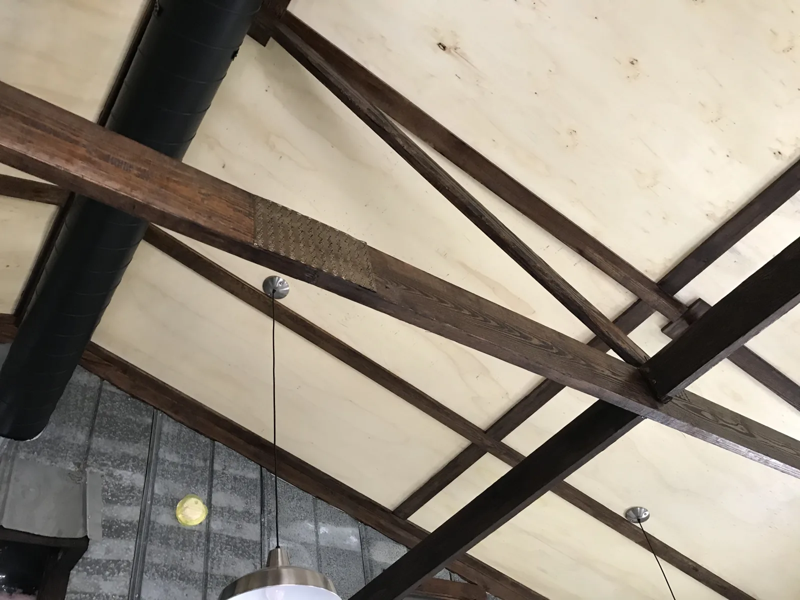 Interior view of stained engineered roof trusses by Hoover Trusses