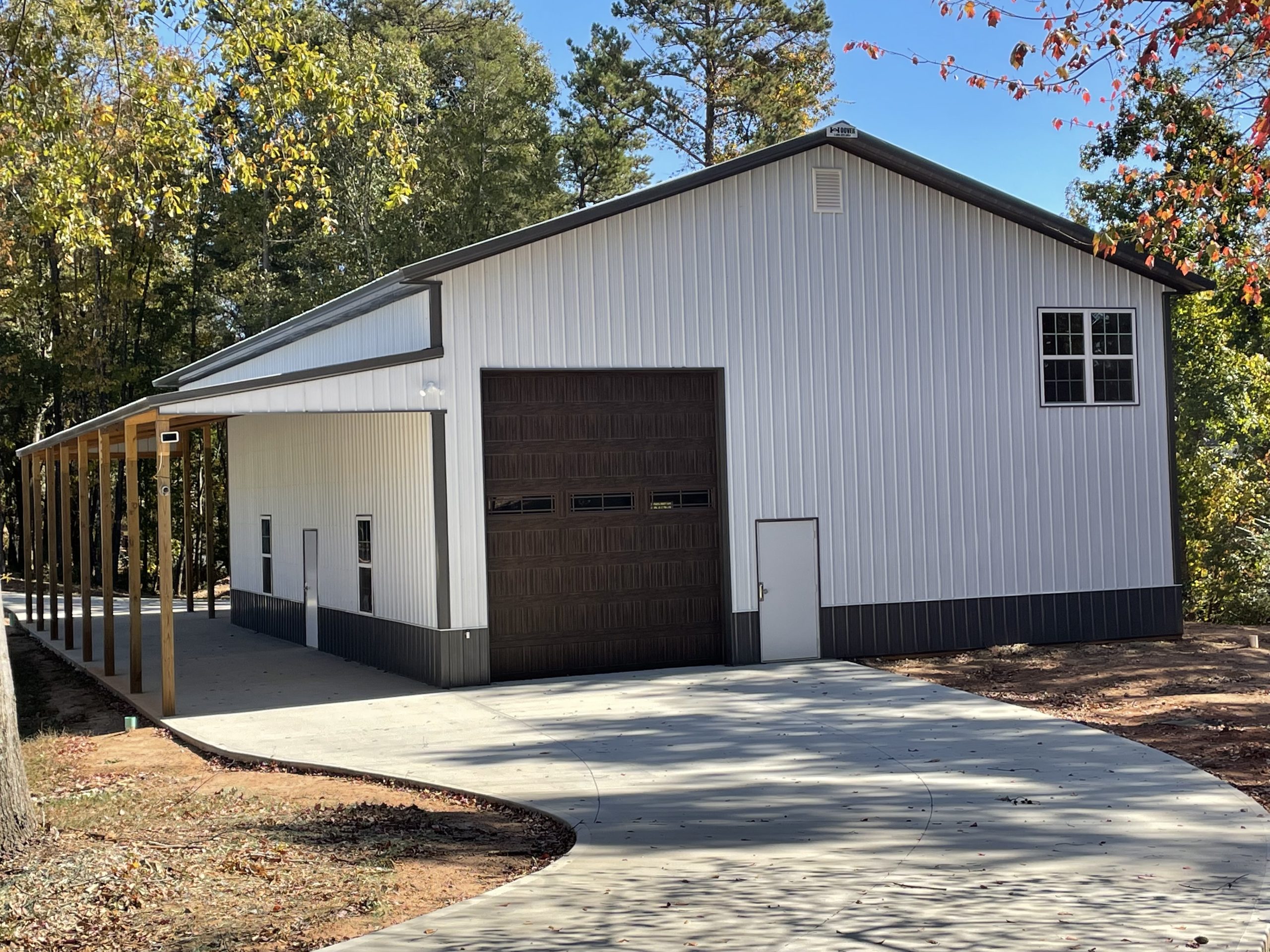 Custom pole building garage with covered wood carport built by Hoover Building Systems