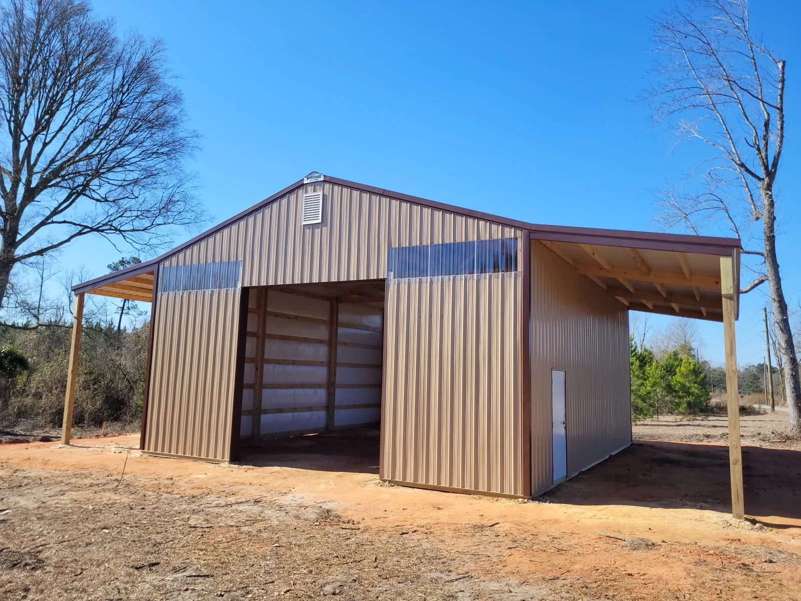 Pole barn with two lean-tos, brown roof and tan walls, built by Hoover Buildings