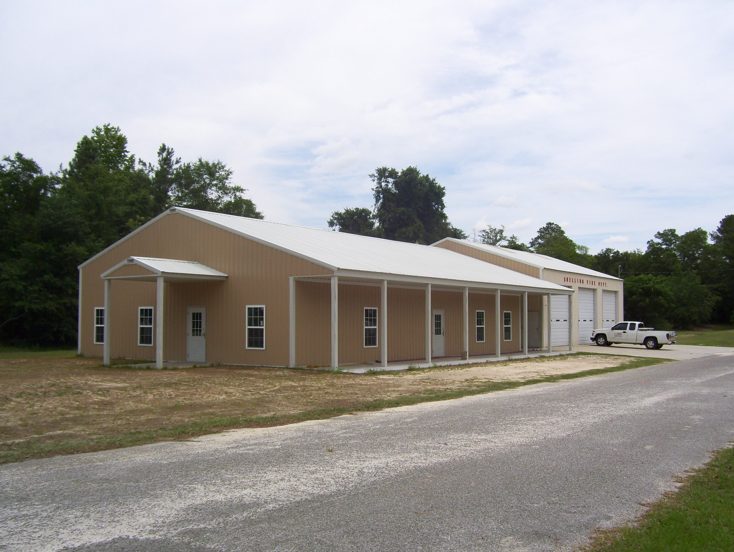 A long Hoover-built commercial pole building with covered porch, representing Hoover Building Systems today
